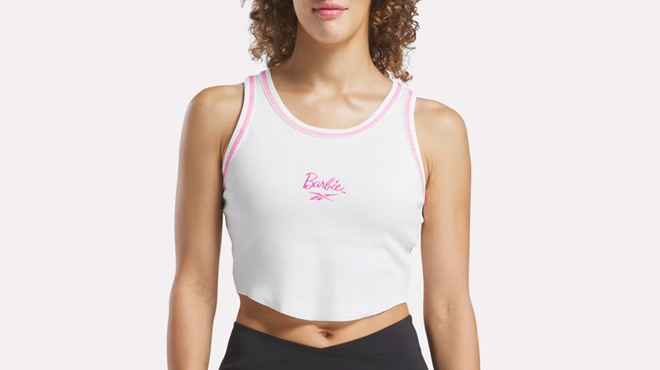 A Woman Wearing Reebok x Barbie Tank Top