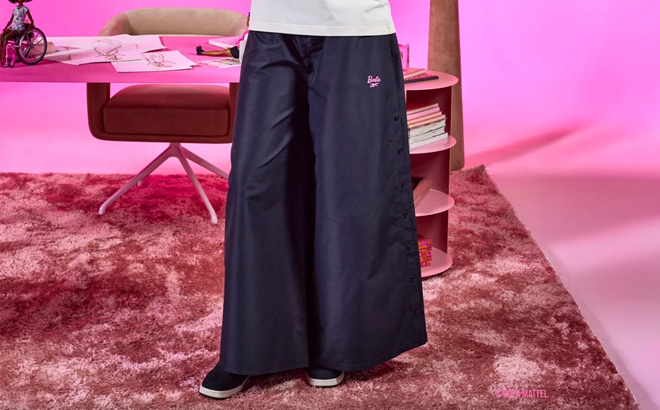 A Woman Wearing Reebok x Barbie Wide Leg Track Pants