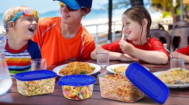 A family having an outdoor picnic using Chef Buddy 54 Piece Food Storage Container Set