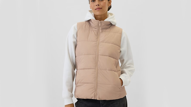 A lady wearing a GAP Factory ColdControl Puffer Vest in warm golden brown