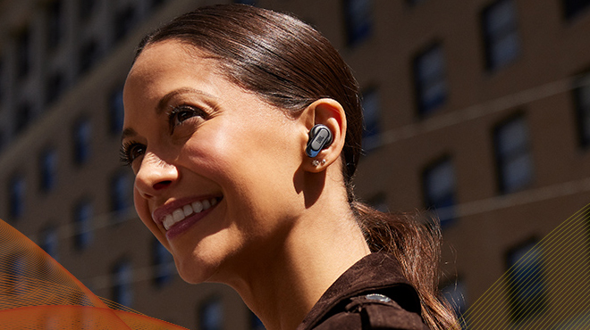 A lady wearing and listening to a JBL True Wireless Earbuds