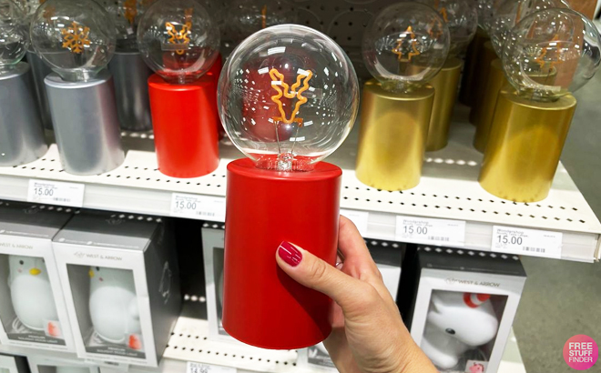 A person holding a Wondershop Reindeer Warm Christmas Filament Bulb at Target