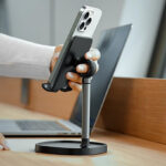 A person holding her phone that is mounted on a Lisen Desk Phone Stand