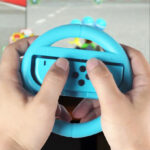 A person playing with Rocketfish Joy Con Racing Wheel