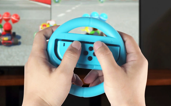 A person playing with Rocketfish Joy Con Racing Wheel