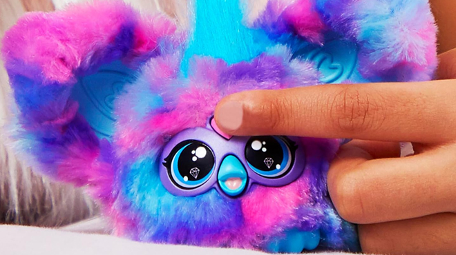 A person playing wth Furby Furblets Luv Lee Mini Friend