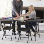 Family Sitting at a Cosco 6 Foot Premium Folding Table in Black