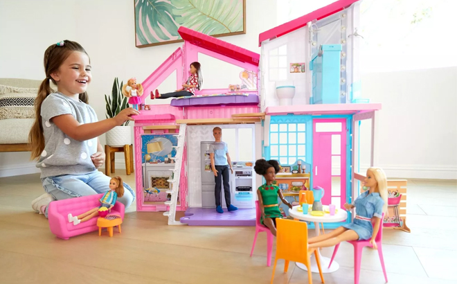 Girl Playing with Barbie Malibu House