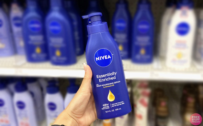 Hand holding Nivea Essentially Enriched Body Lotion