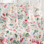 Holiday Printed Birch Trail Fleece Throw on a Sofa