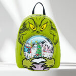 Loungefly Grinch Glow In The Dark Mini Backpack on a Table