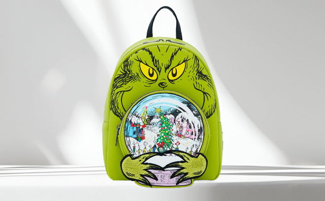 Loungefly Grinch Glow In The Dark Mini Backpack on a Table