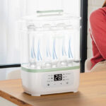 Momcozy Bottle Sterilizer and Dryer on the counter