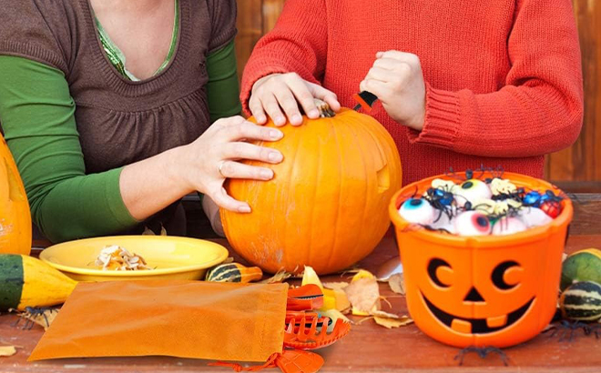 People carving a Pumpkin with Hansgo Pumpkin Carving Kit 22 Piece Set