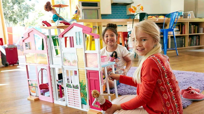 People playing with Barbie 3 Story Doll House Playset with Accessories