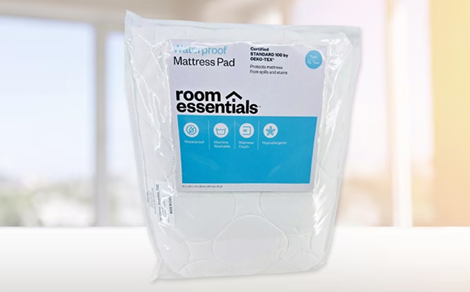 Room Essentials Waterproof Quilted Mattress Pad on a Table