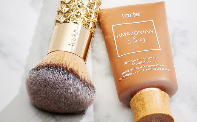 Tarte Amazonian Clay 16 Hour Foundation with Golden Era Brush on a Table