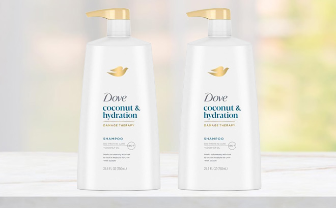 Two Bottles of Dove Ultra Care Shampoo on a Table