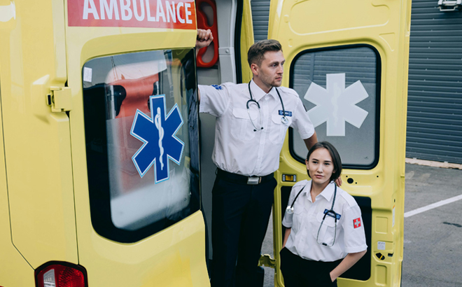 Two Paramedics standing in front of an Ambulance Car