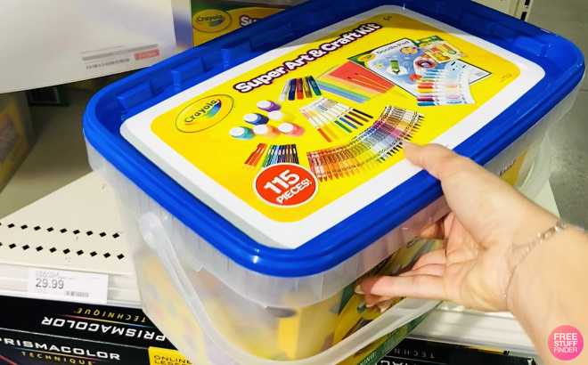 a Peson Holding Crayola 115 Piece Art Craft Kit