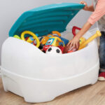 A Boy Putting Away Toys in the Little Tikes Play 'N Store Toy Chest