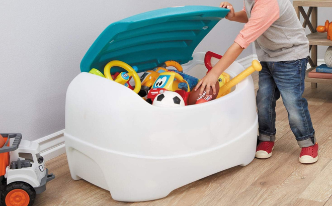 A Boy Putting Away Toys in the Little Tikes Play 'N Store Toy Chest