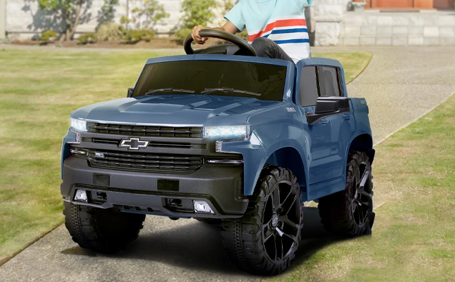 A Child Driving the Licensed Chevrolet Silverado 12V Kids Electric Ride on Truck in Blue