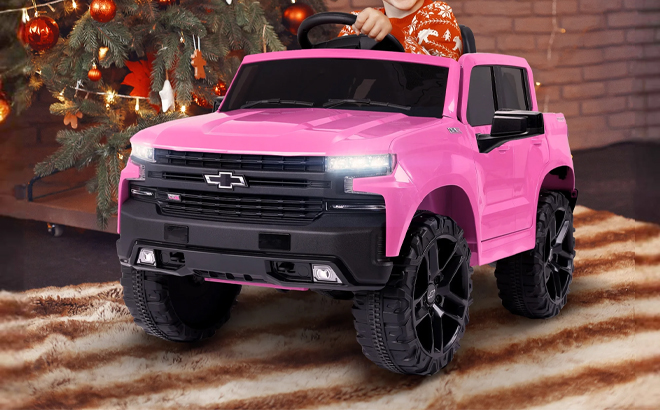 A Child Driving the Licensed Chevrolet Silverado 12V Kids Electric Ride on Truck in Pink