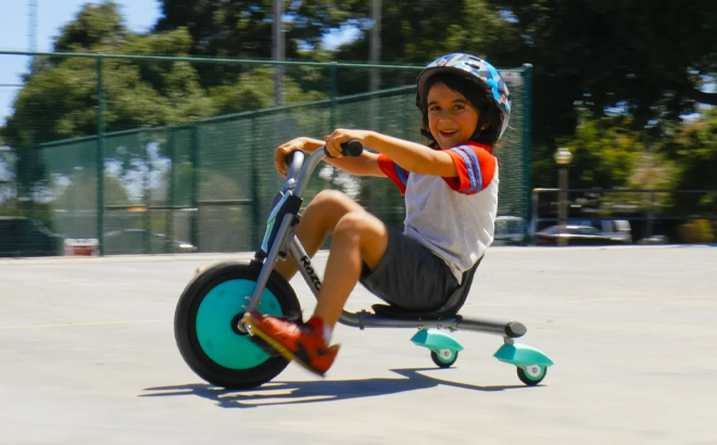 A Child Driving the Razor RipRider 360 Mini Teal 360 Degrees Caster Tricycle