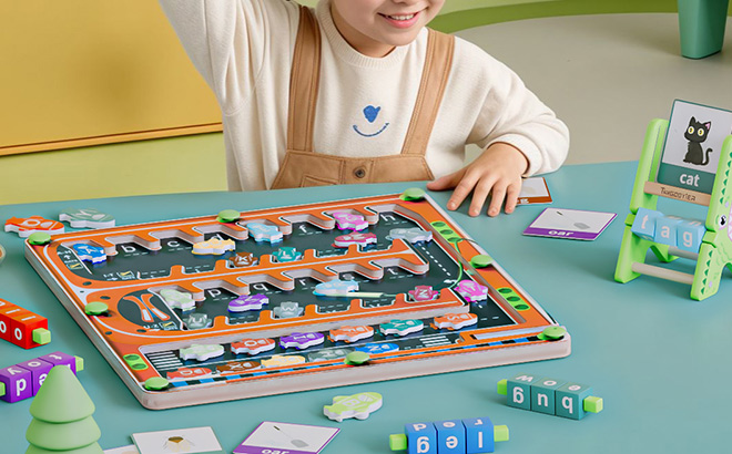 A Child Playing with Magnetic Alphabet Letter Maze