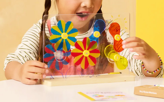 A Child Playing with One of the KiwiCo Kits