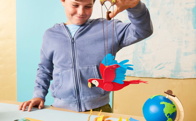 A Child Playing with One of the KiwiCo World Sets