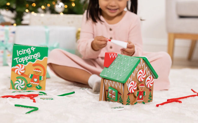 A Child Playing with the Melissa Doug Wooden Gingerbread House