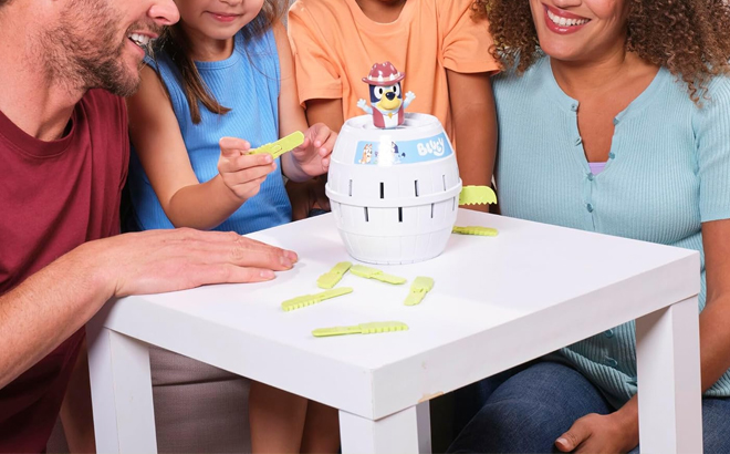 A Family Playing with the Bluey Pop Up Family Game on a Table