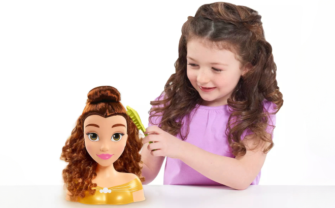 A Girl Playing with Disney Princess Belle Styling Head