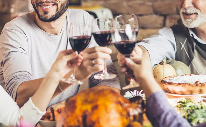 A Group of People Enjoying a Meal and Toasting with Wine Glasses