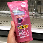 A Hand holding BIC Silky Touch 10 Count Razors Pouch