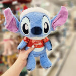 A Hand holding a Disney Baby Stitch Holiday Plush