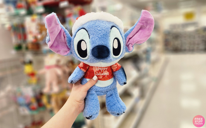 A Hand holding a Disney Baby Stitch Holiday Plush