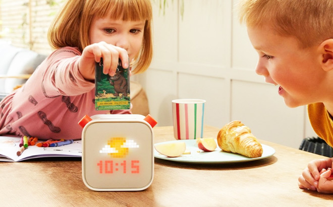 A Little Girl Putting an Audiobook Card into Yoto Player