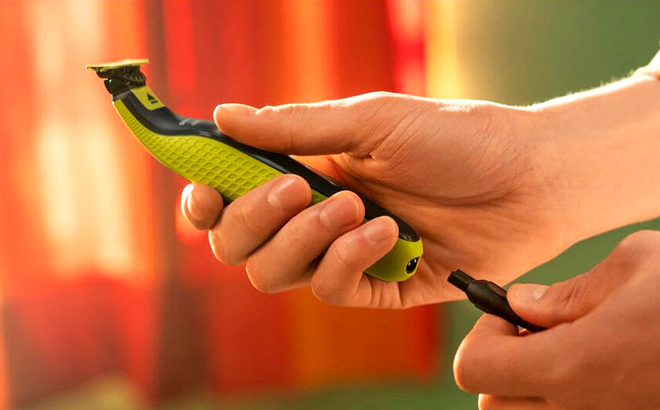 A Man Holding Philips Norelco OneBlade 360 Electric Shaver and Trimmer