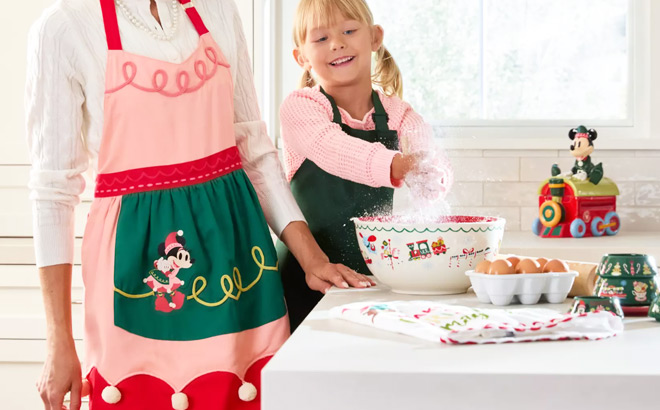 A Mother in Minnie Mouse Holiday Apron and Daughter Baking