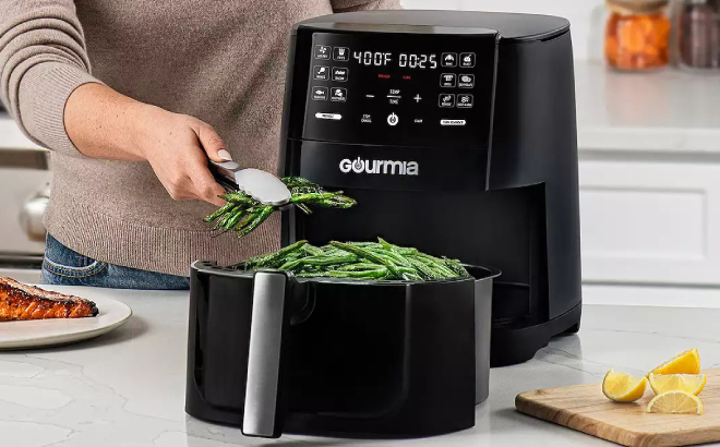 A Person Cooking String Beans Using Gourmia Air Fryer