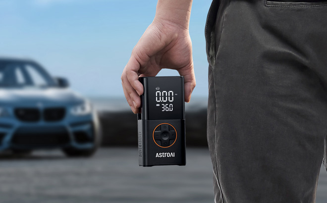 A Person Holding AstroAI L7 Tire Inflator Portable Air Compressor