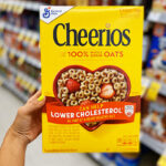 A Person Holding Cheerios Cereals