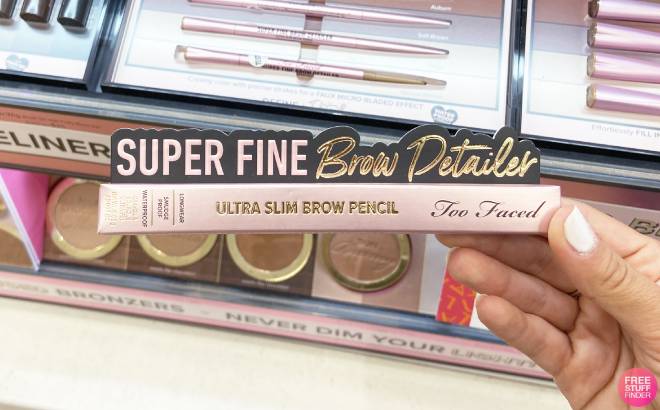 A Person Holding Too Faced Super Fine Brow Detailer Retractable Eyebrow Pencil