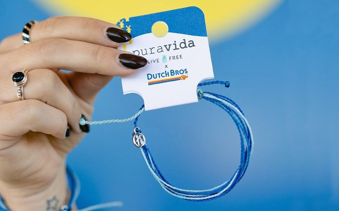 A Person Holding a Pura Vida x Dutch Bros Bracelet