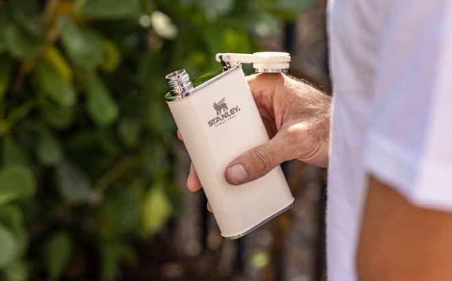 A Person Holding a Stanley Classic Easy Fill Wide Mouth Flask