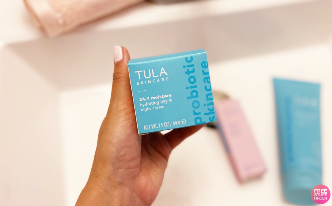 A Person Holding a Tula 24 7 Moisture Hydrating Day Night Cream