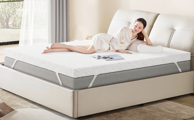 A Person Laying Down on a Bed with Memory Foam Mattress Topper